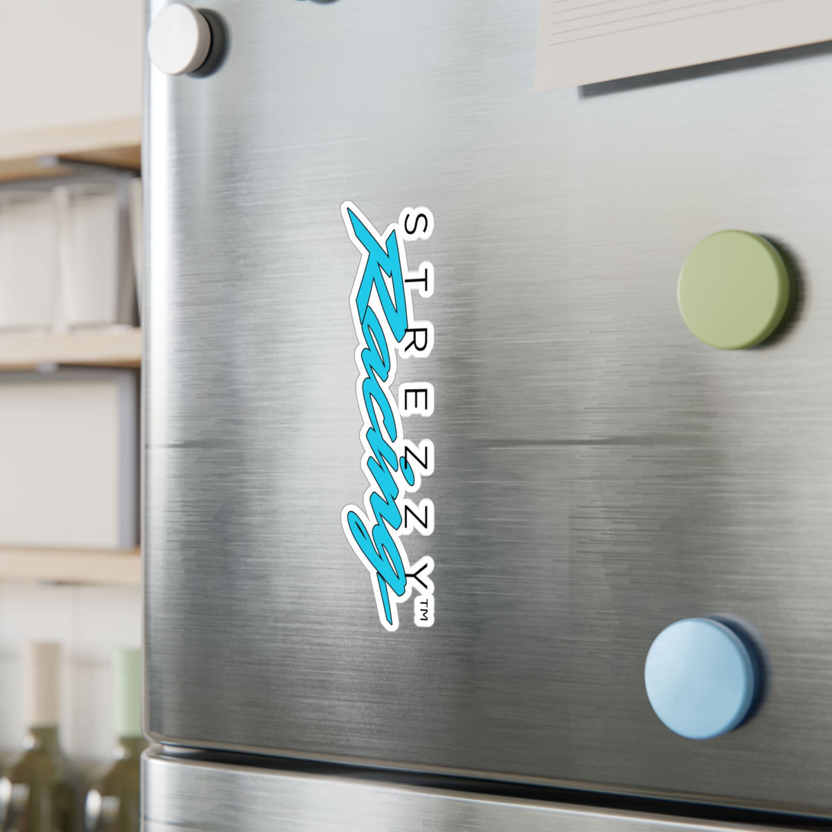 Kiss-cut racing logo sticker on stainless appliance, teal “Kaching” script