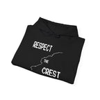 Black pullover hoodie folded flat with front graphic print and drawstring hood