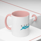 White mug with pink lid, pink handles, and “Racing” graphic on the front