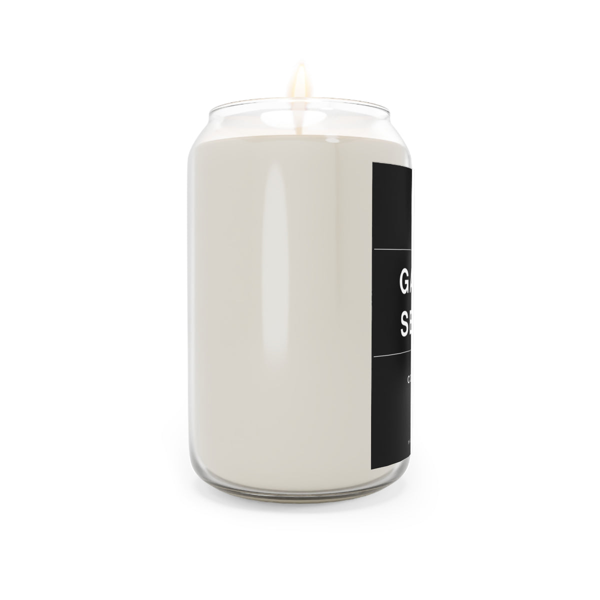 Off-white soy candle in clear glass jar with black side label and burning wick