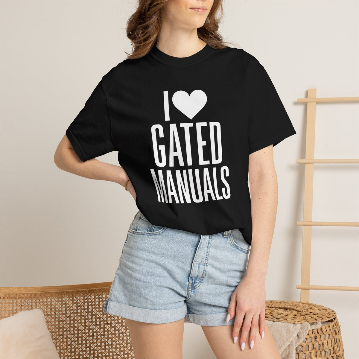 Black crew-neck T-shirt with heart "GATED MANUALS" graphic on model