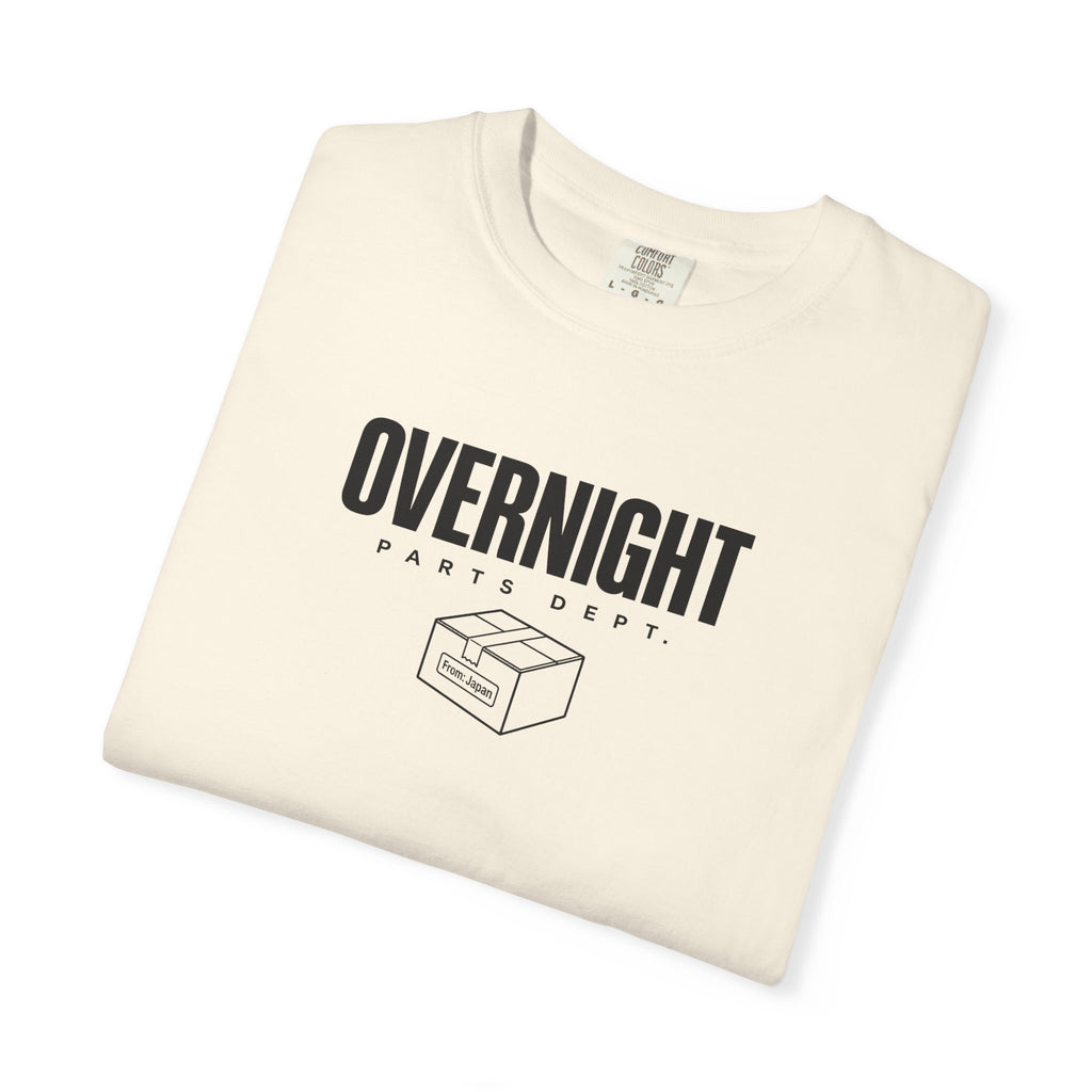 Ivory crew-neck T-shirt with “OVERNIGHT” front box-style graphic