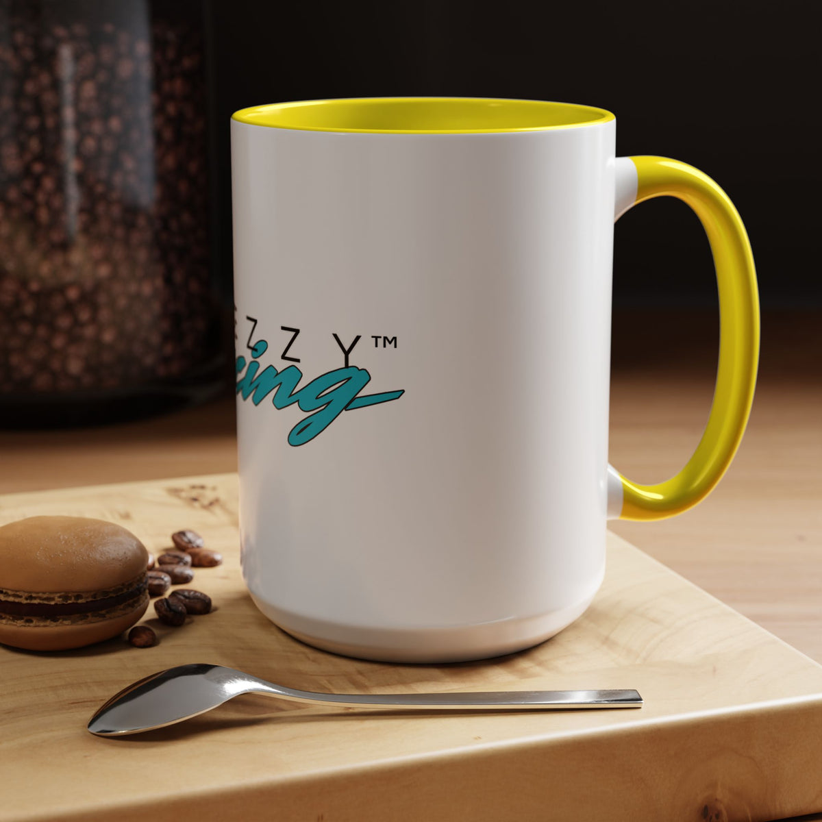 White racing mug with yellow rim and yellow handle, logo print visible on front