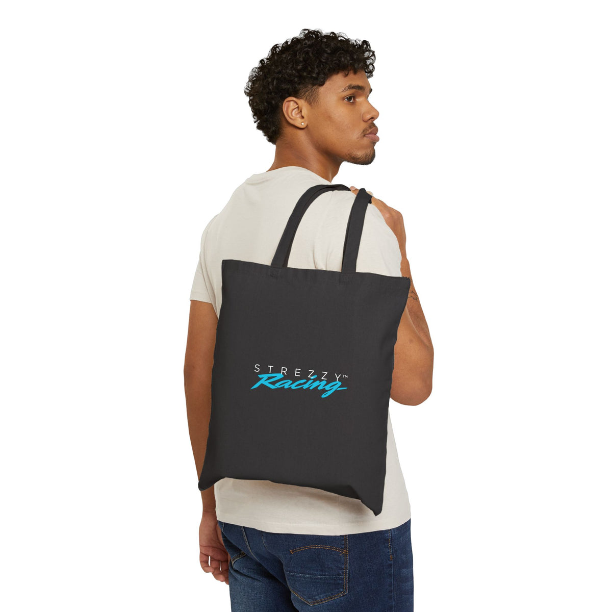 Black canvas tote bag worn on back, Strezzy Racing logo front.