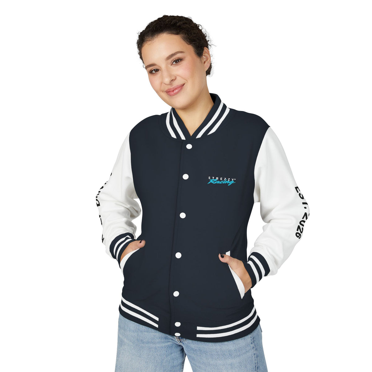 Woman wearing dark varsity racing jacket with white sleeves, striped rib trim, snap-button front, logo