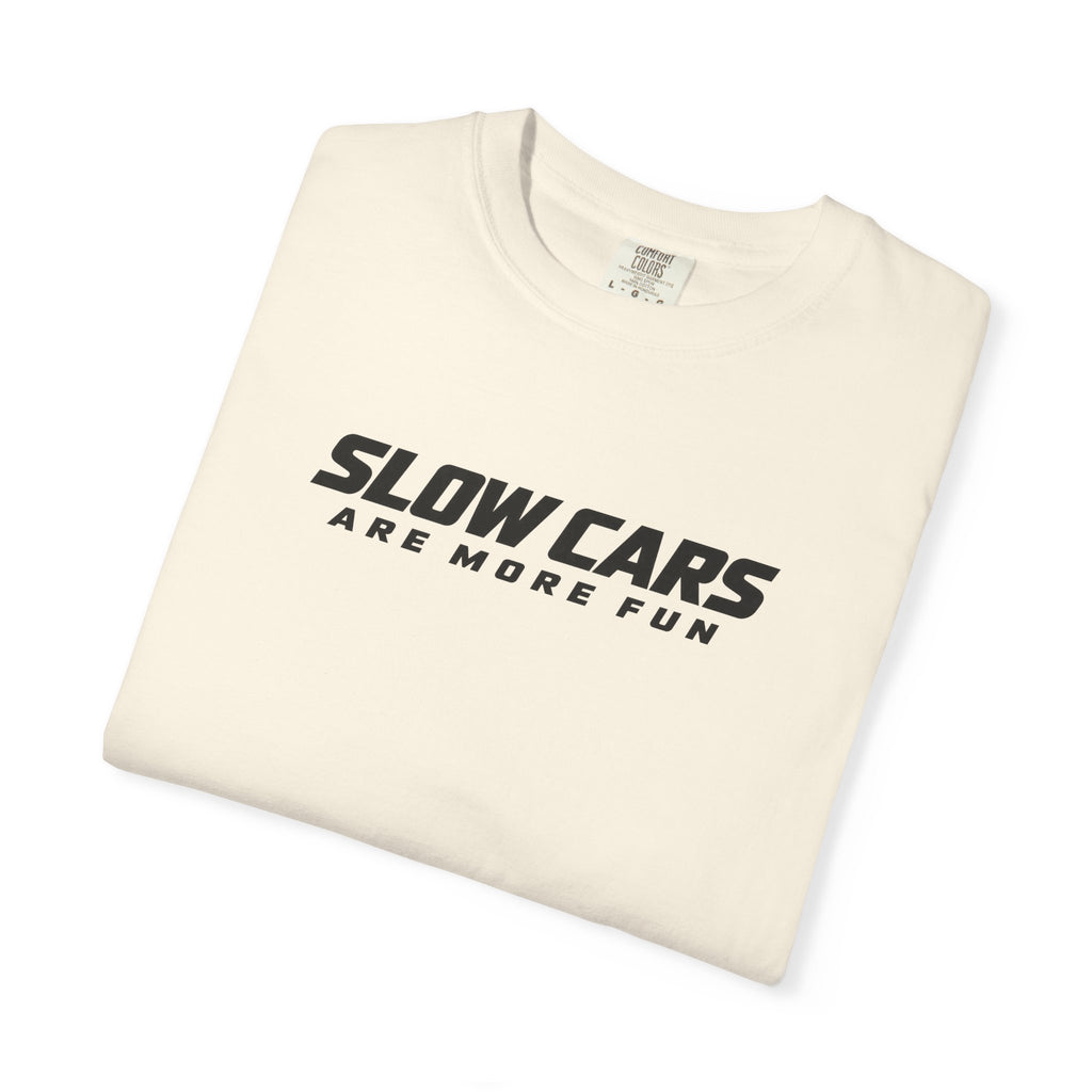 Ivory T-shirt folded with "SLOWCARS ARE MORE FUN" graphic across the front