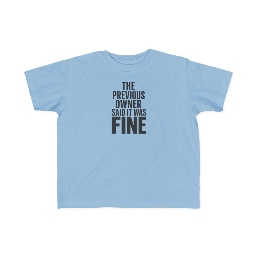 Light blue toddler graphic t-shirt with centered "THE PREVIOUS OWNER SAID IT WAS FINE" text