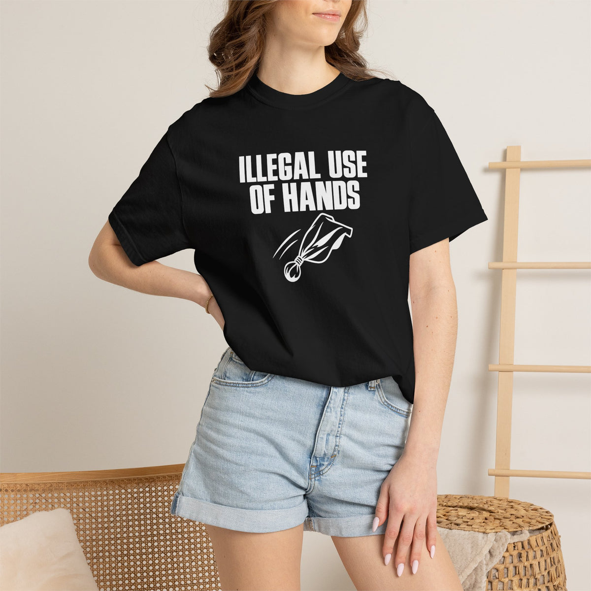Black crew-neck T-shirt worn by model, with 'ILLEGAL USE OF HANDS' chest graphic.