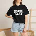Black crew-neck T-shirt worn with light blue denim shorts; front slogan graphic