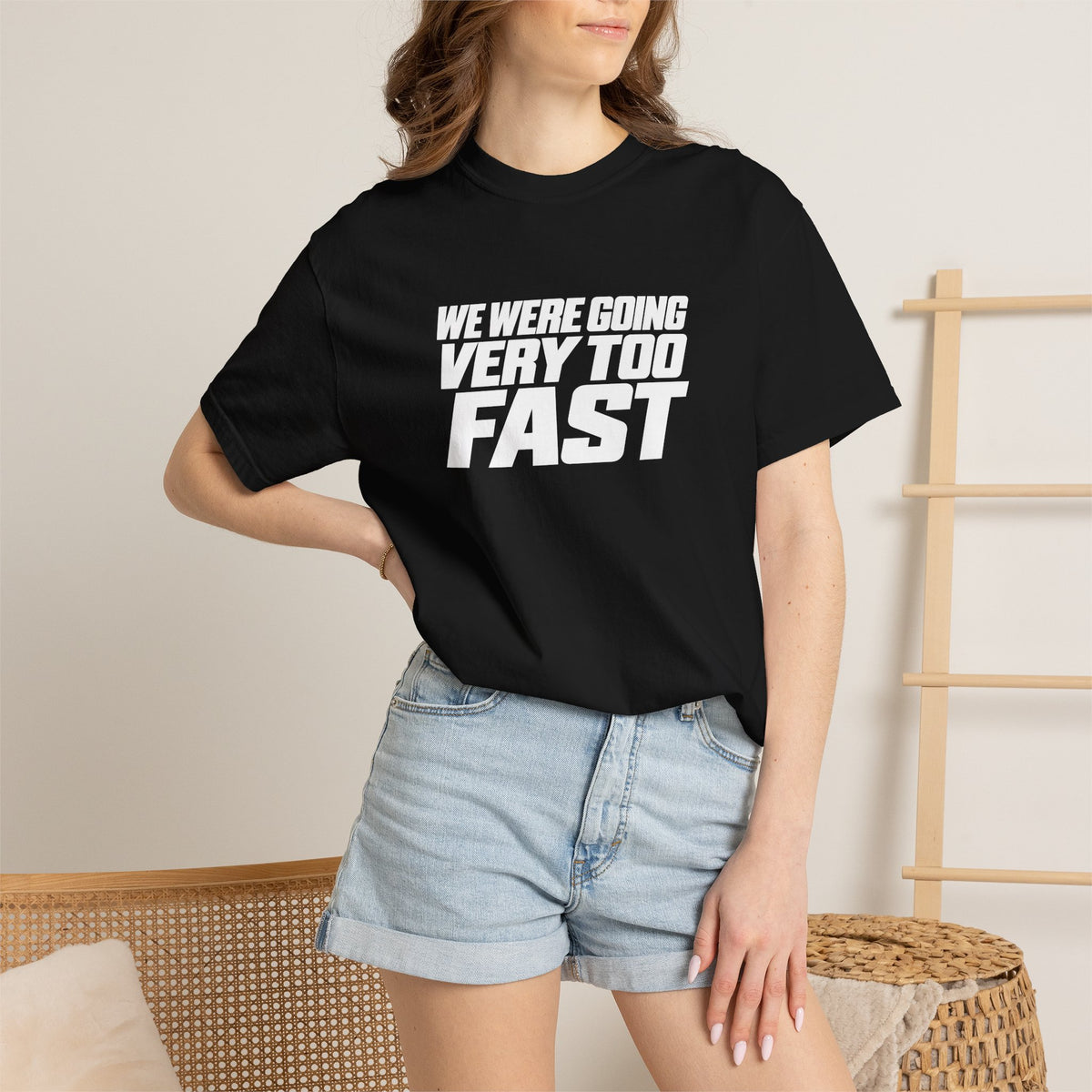 Black crew-neck T-shirt worn with light blue denim shorts; front slogan graphic