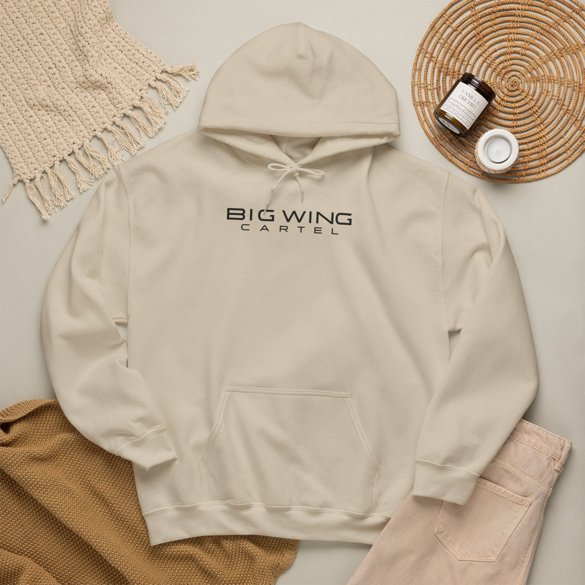 Cream hoodie with front logo print, drawstring hood, and kangaroo pocket.