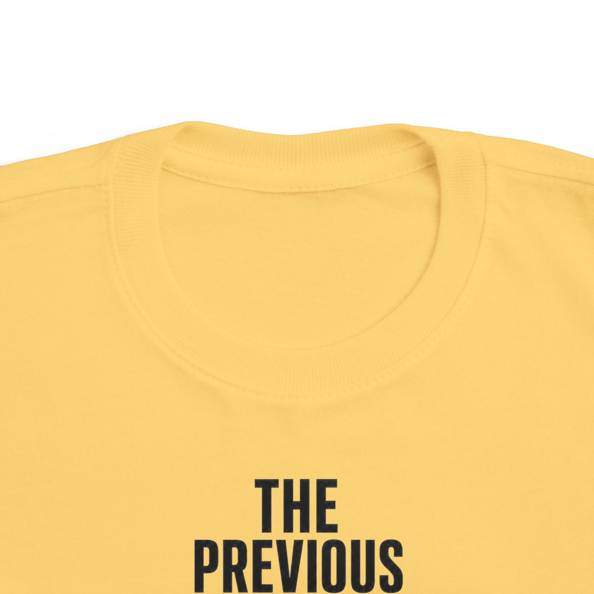 Butter yellow toddler t-shirt back close-up of text "THE PREVIOUS"