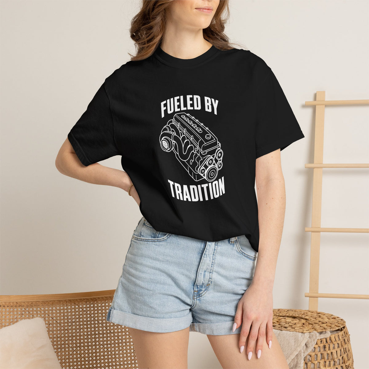 Black T-shirt with front 'Fueled by Tradition' engine graphic worn with denim shorts