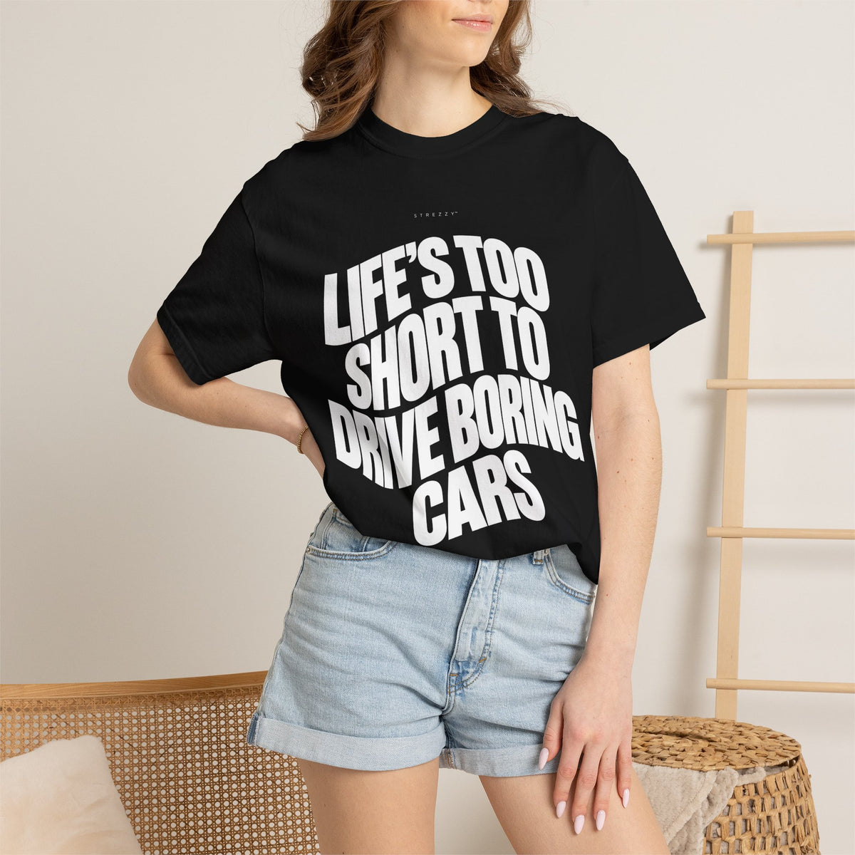 Black short-sleeve graphic T-shirt worn by model, front slogan print