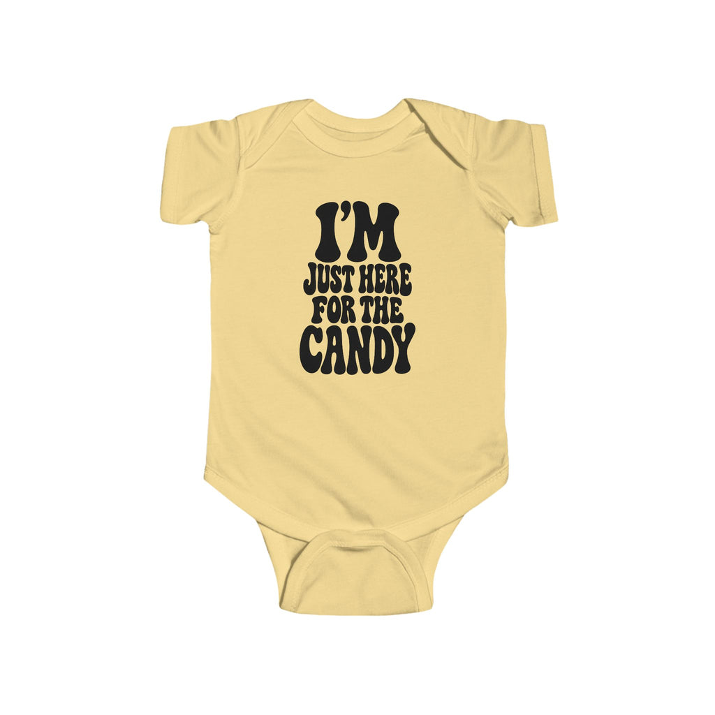 Butter yellow baby bodysuit with "I'm just here for the candy" graphic on the front