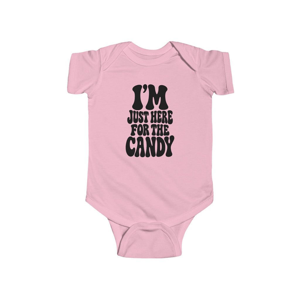 Pink baby bodysuit with "I'm just here for the candy" graphic on the front