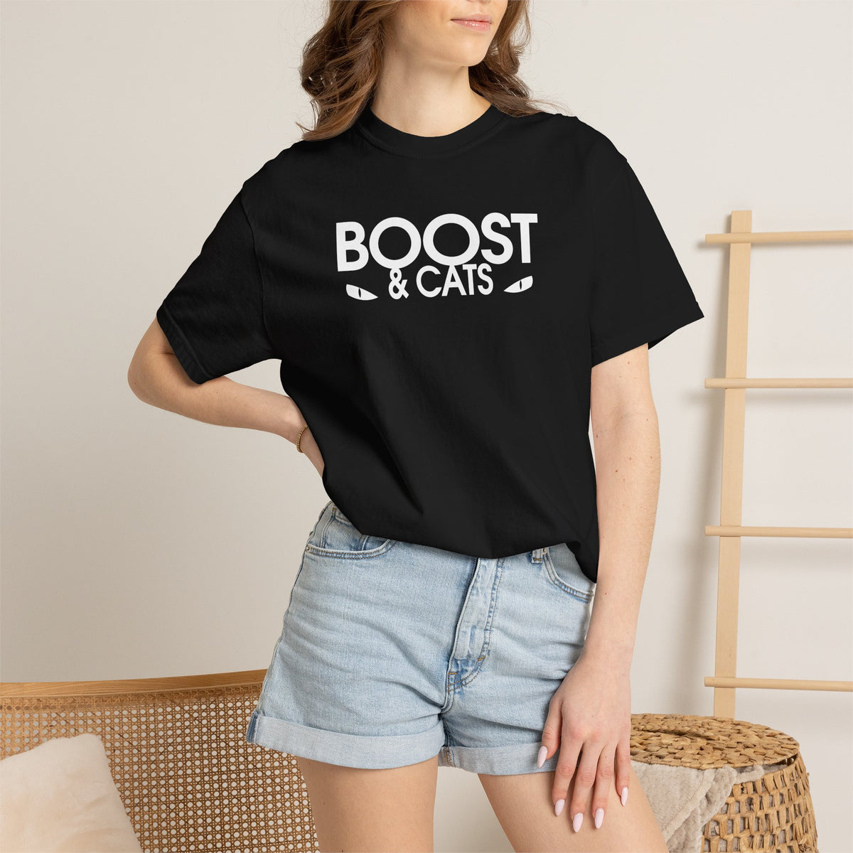 Black crewneck T-shirt with white “BOOST & CATS” graphic, worn by model