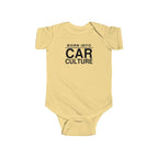 Butter yellow baby bodysuit with short sleeves and front “Born Into Car Culture” graphic