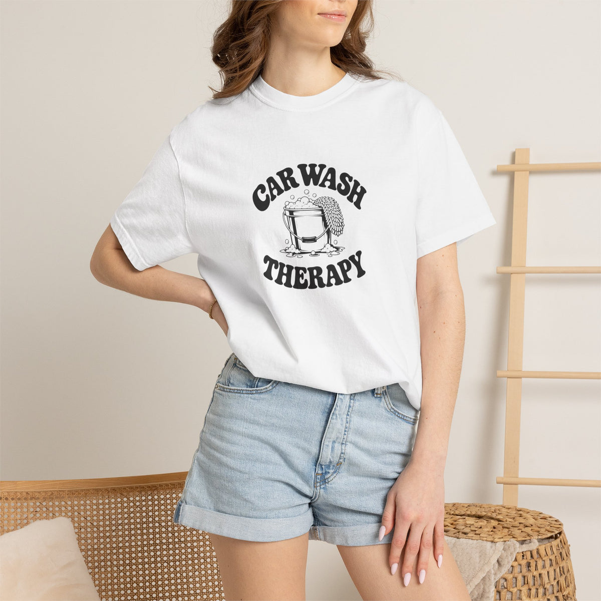 White crewneck T-shirt worn by model with “CAR WASH THERAPY” graphic on chest