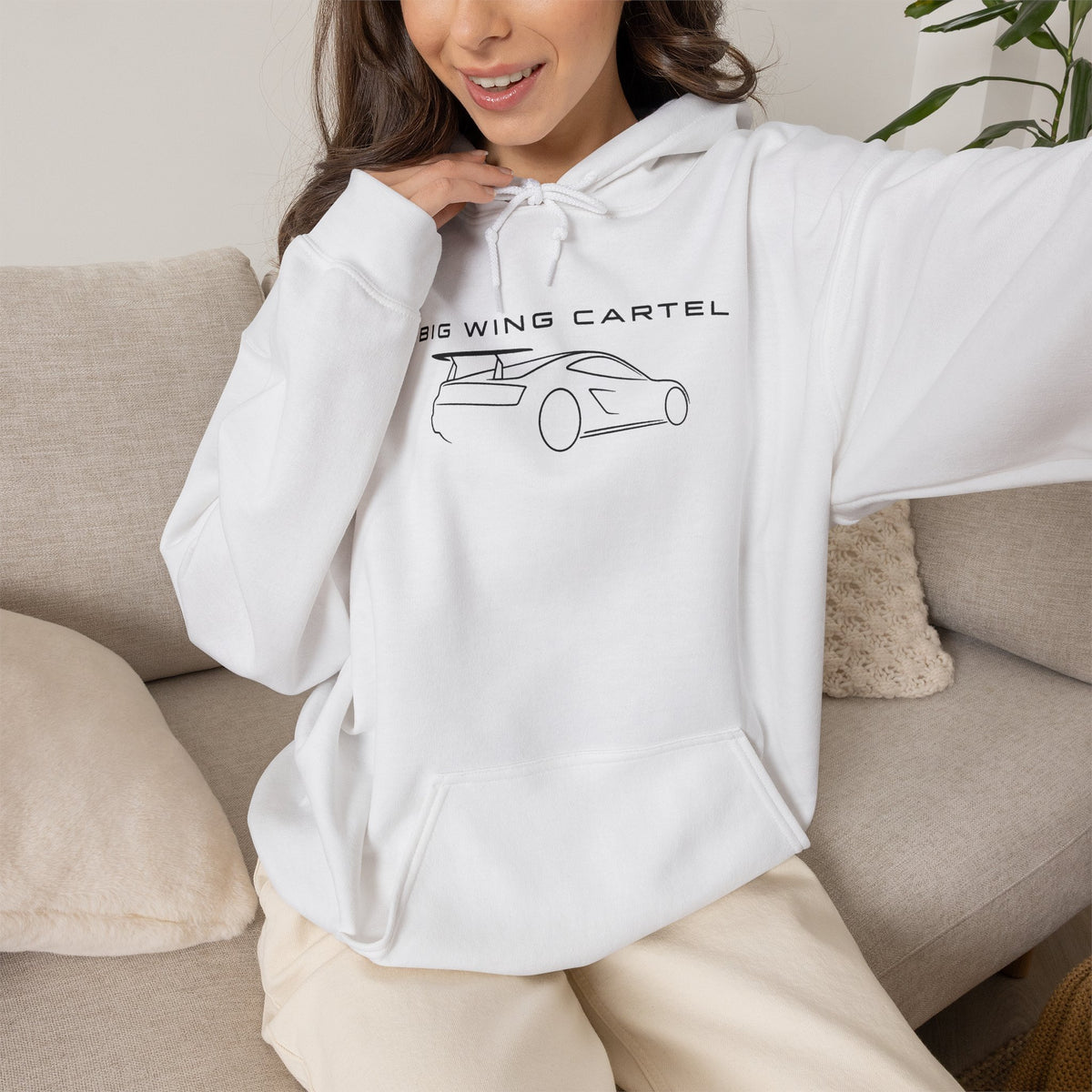 White hoodie on model with BIG WING CARTEL car graphic, drawstring hood and pocket