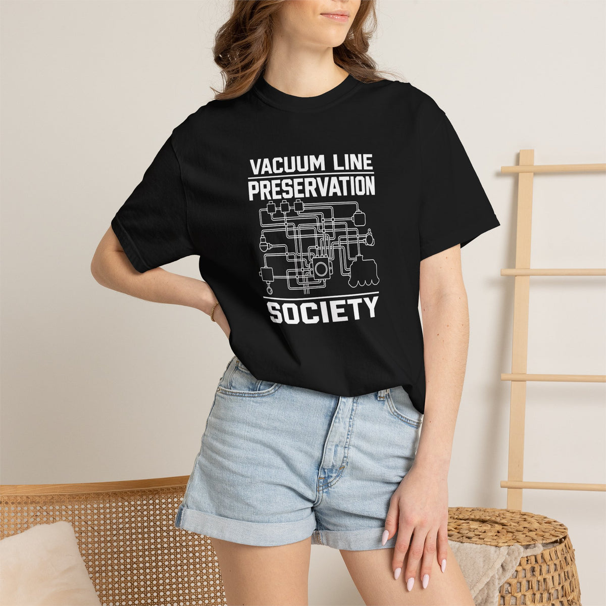 Black t-shirt with front Vacuum Line Preservation Society graphic on a woman