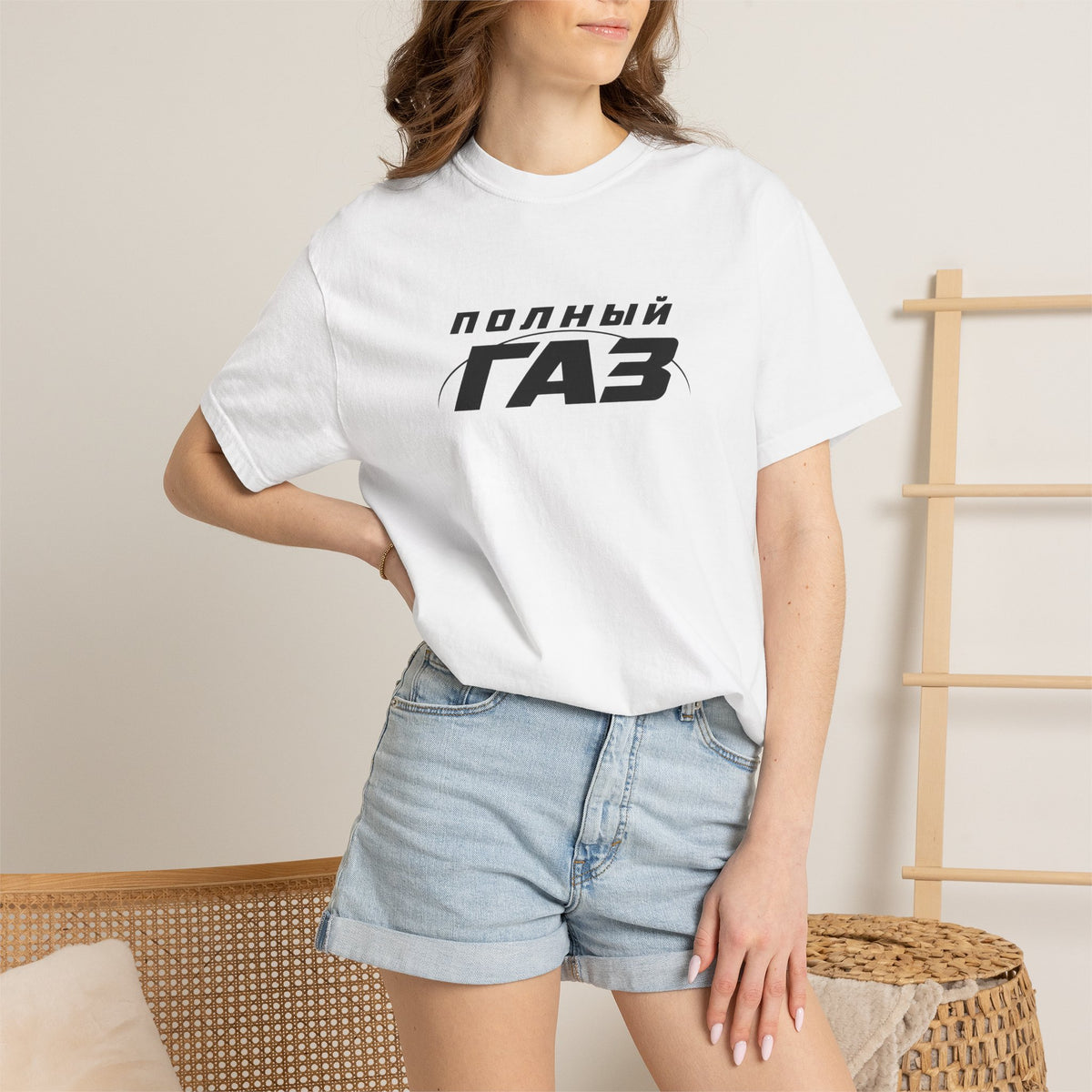 White crew-neck T-shirt with front logo print, worn with blue denim shorts