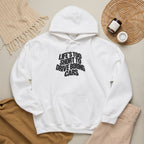 White hoodie worn with hood and front slogan graphic.