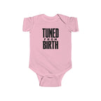 Pink baby bodysuit with short sleeves and “TUNED FROM BIRTH” front graphic
