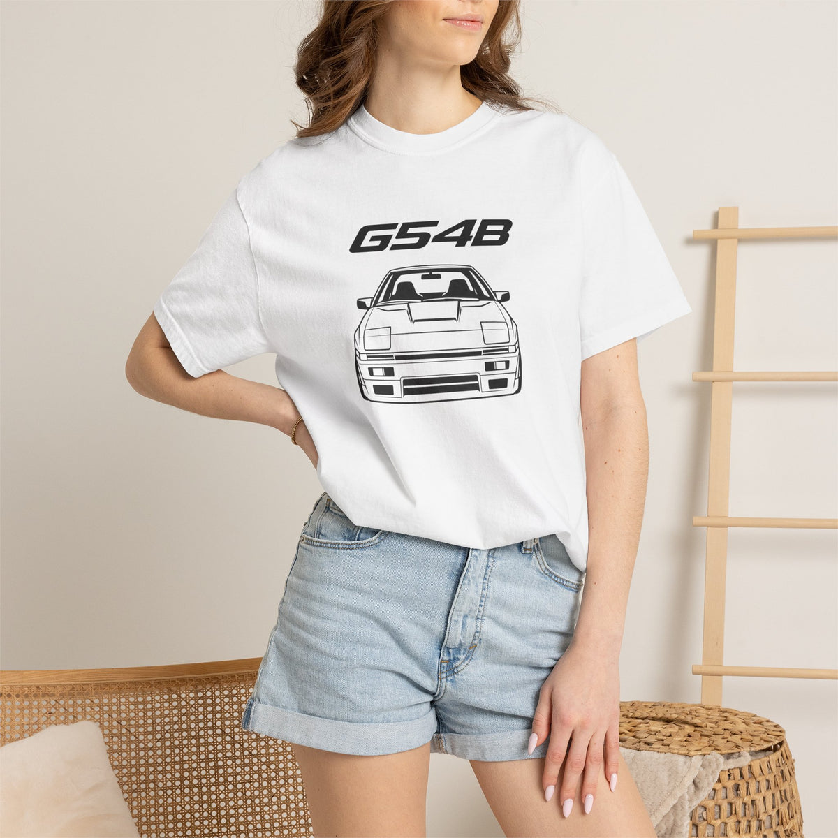 White JDM T-shirt worn by model, featuring G54B and front car graphic