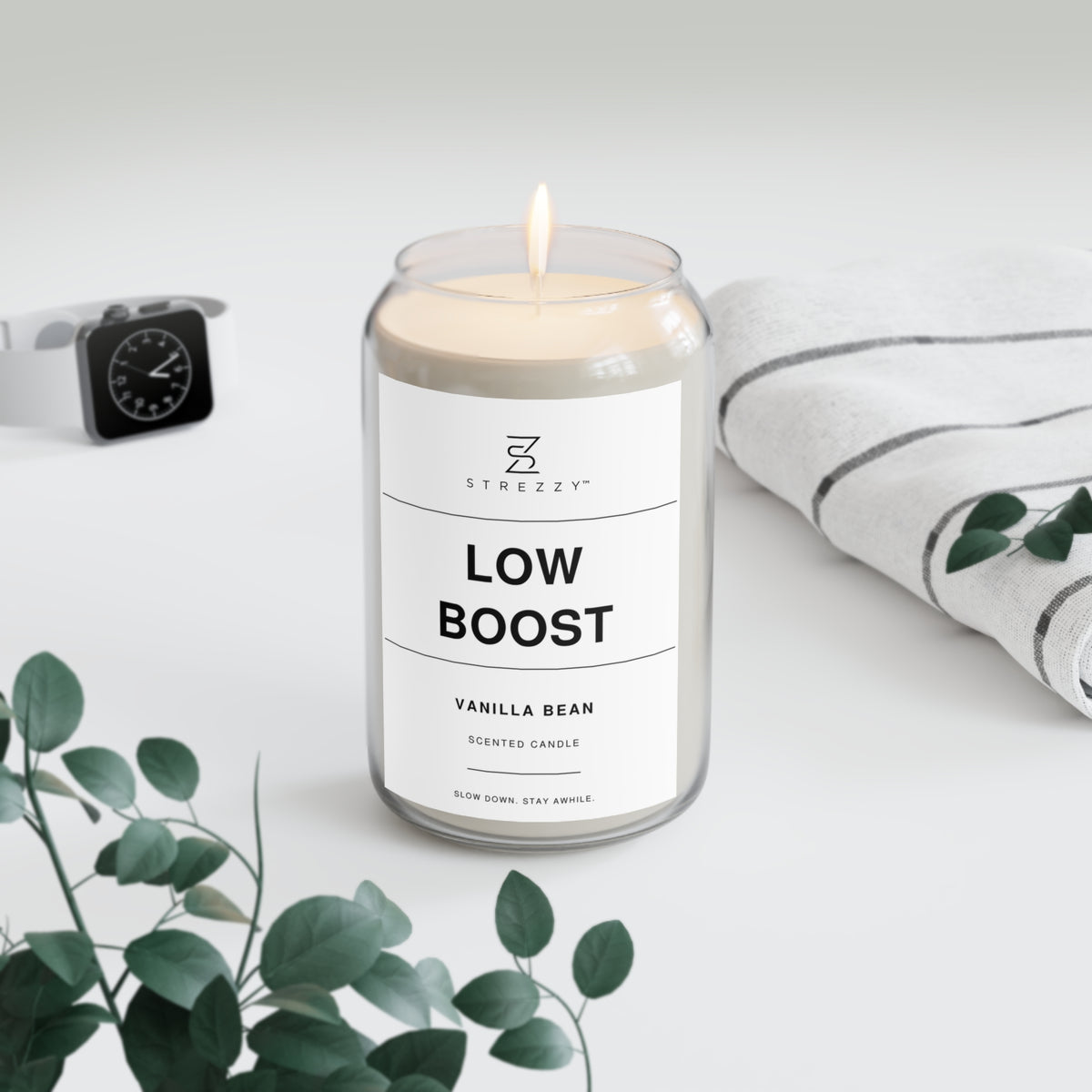 Soy candle in clear jar with flame and Low Boost Vanilla Bean label