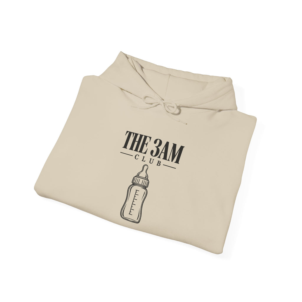 Sand baby hoodie folded with “THE 3AM CLUB” logo and bottle graphic on chest.