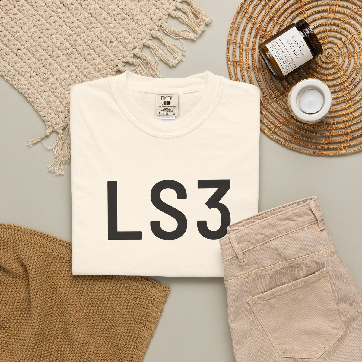 White crewneck T-shirt with large black “LS3” logo print on the front