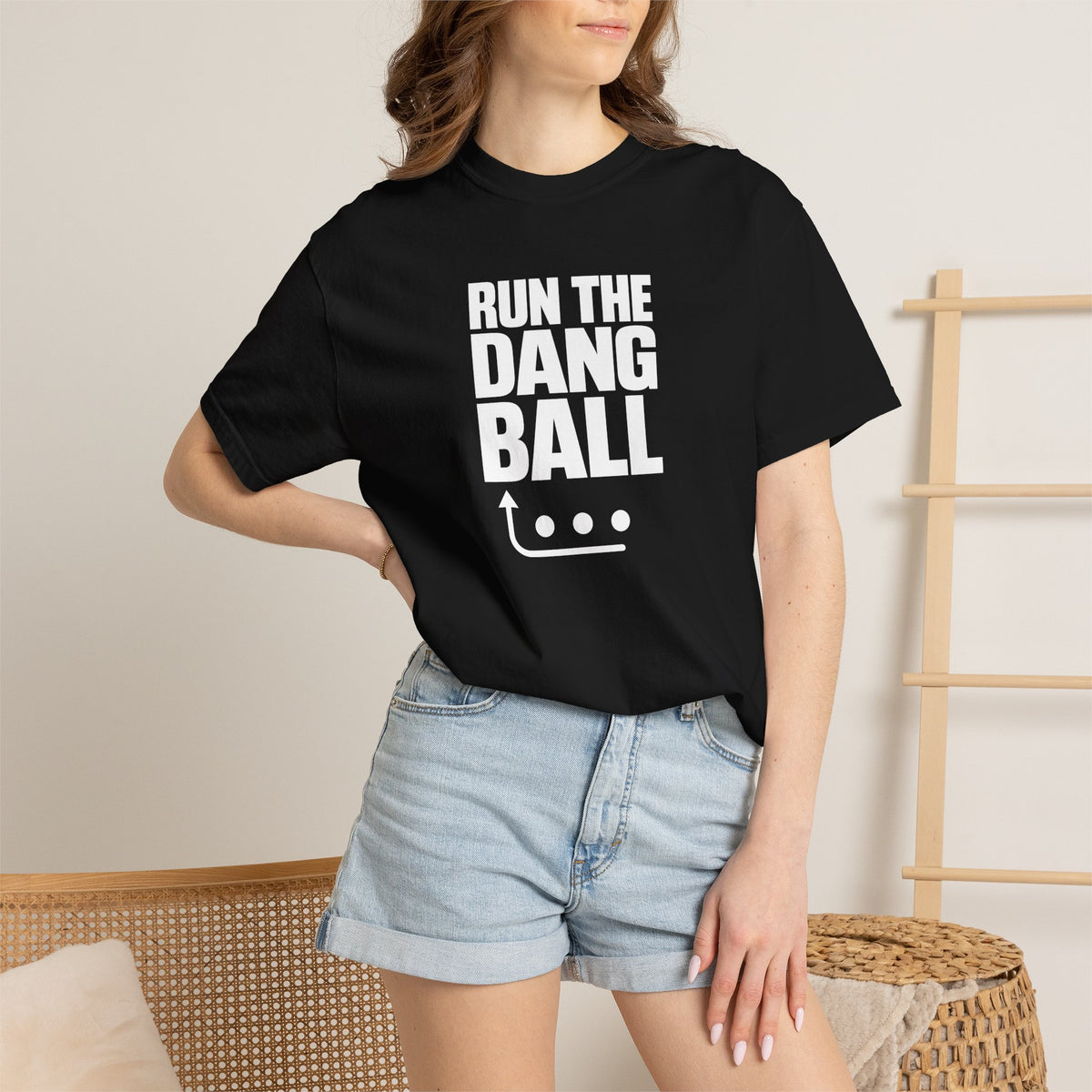 Black football T-shirt on person with 'RUN THE DANG BALL' graphic at center