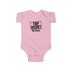 Pink baby bodysuit with short sleeves and “Top Secret Co-pilot” chest graphic