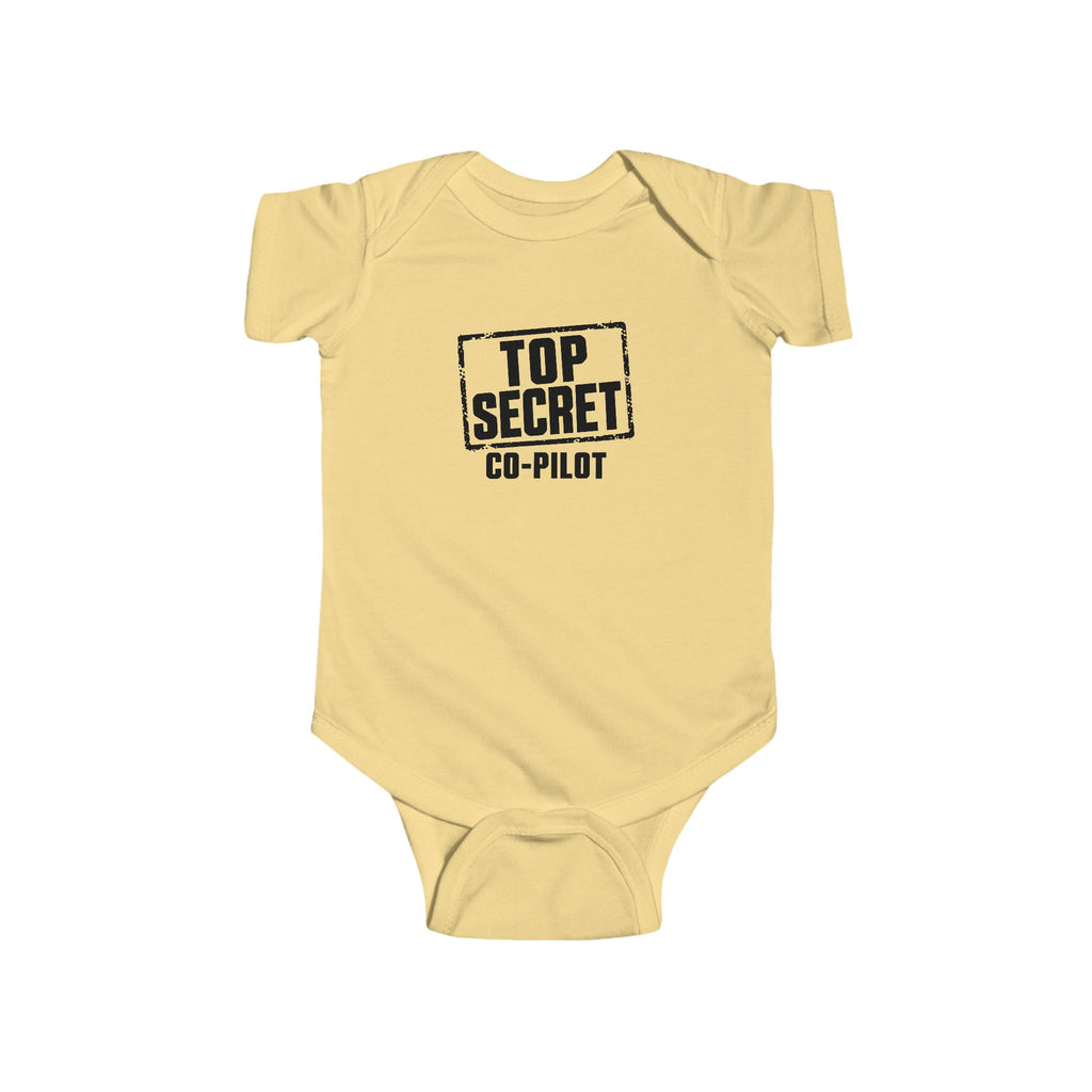 Butter yellow baby bodysuit with short sleeves and “Top Secret Co-pilot” chest graphic