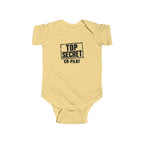 Butter yellow baby bodysuit with short sleeves and “Top Secret Co-pilot” chest graphic