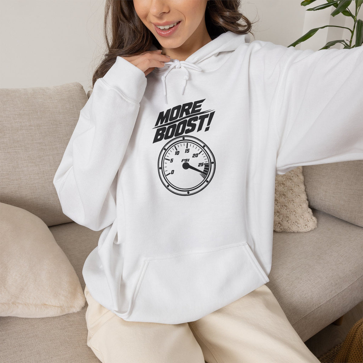 White pullover hoodie on model with front “More Boost!” graphic and drawstring hood