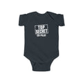 Black baby bodysuit with short sleeves and “Top Secret Co-pilot” chest graphic