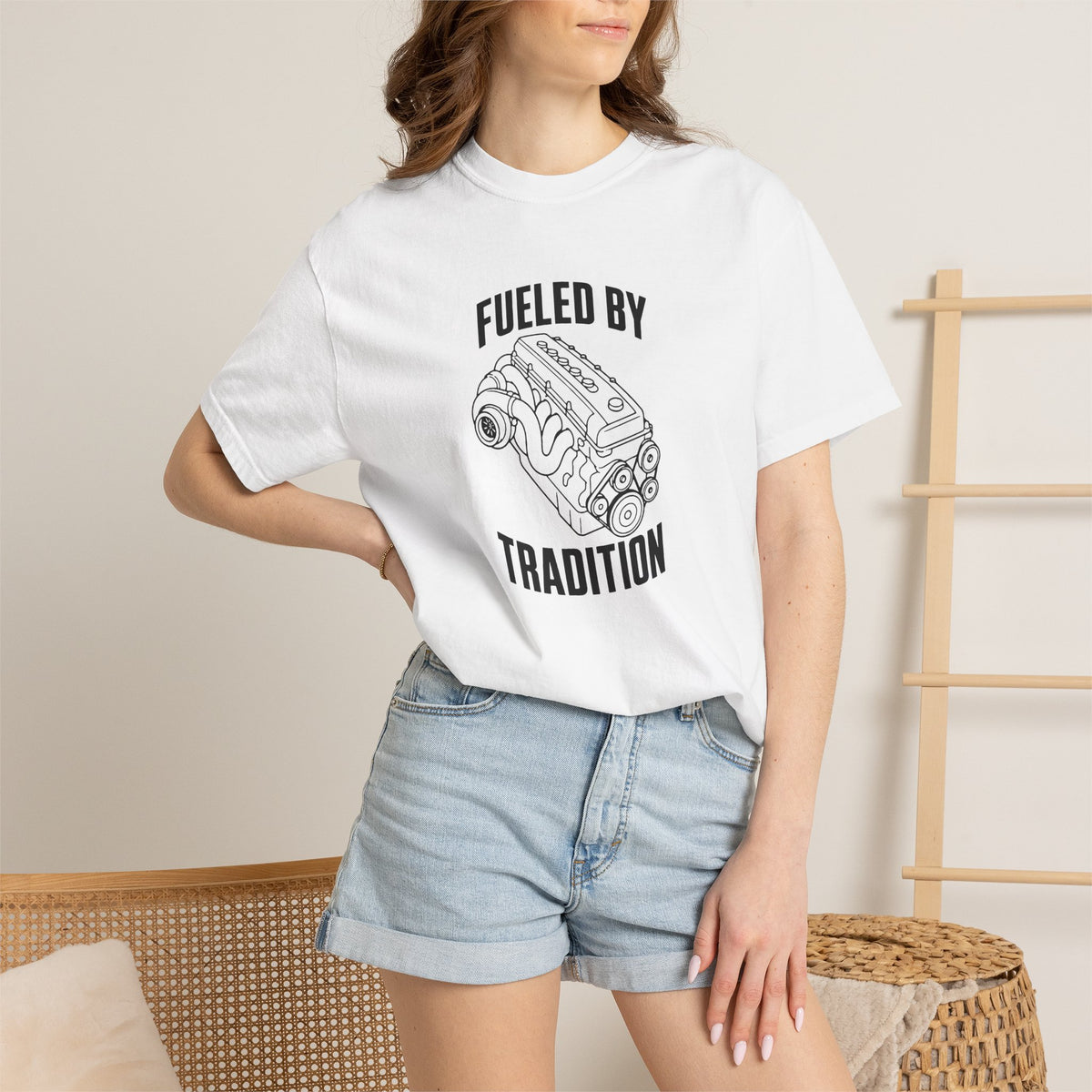White T-shirt with front 'Fueled by Tradition' engine graphic worn with denim shorts